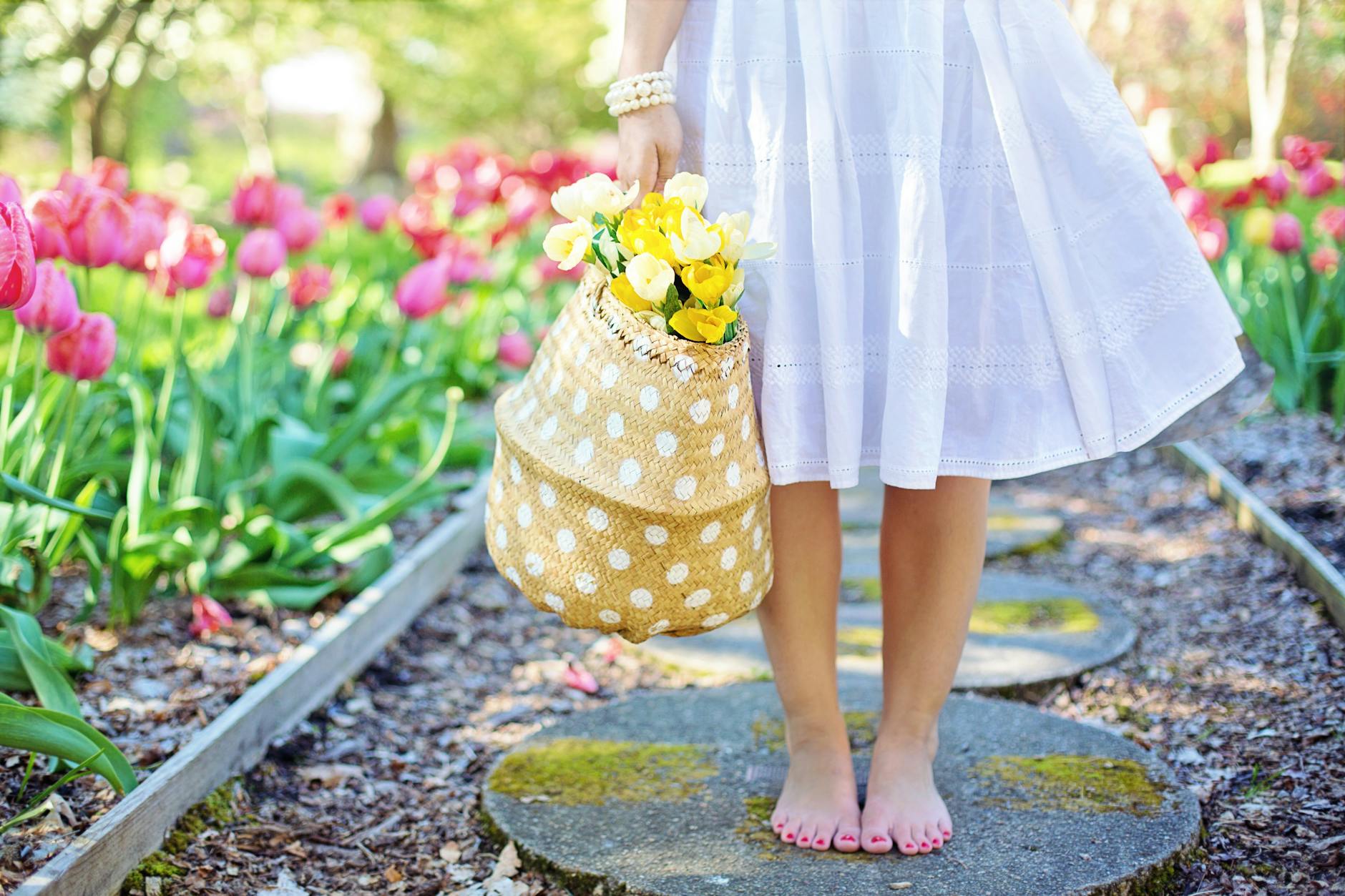 woman holding brown basket with yellow flowers