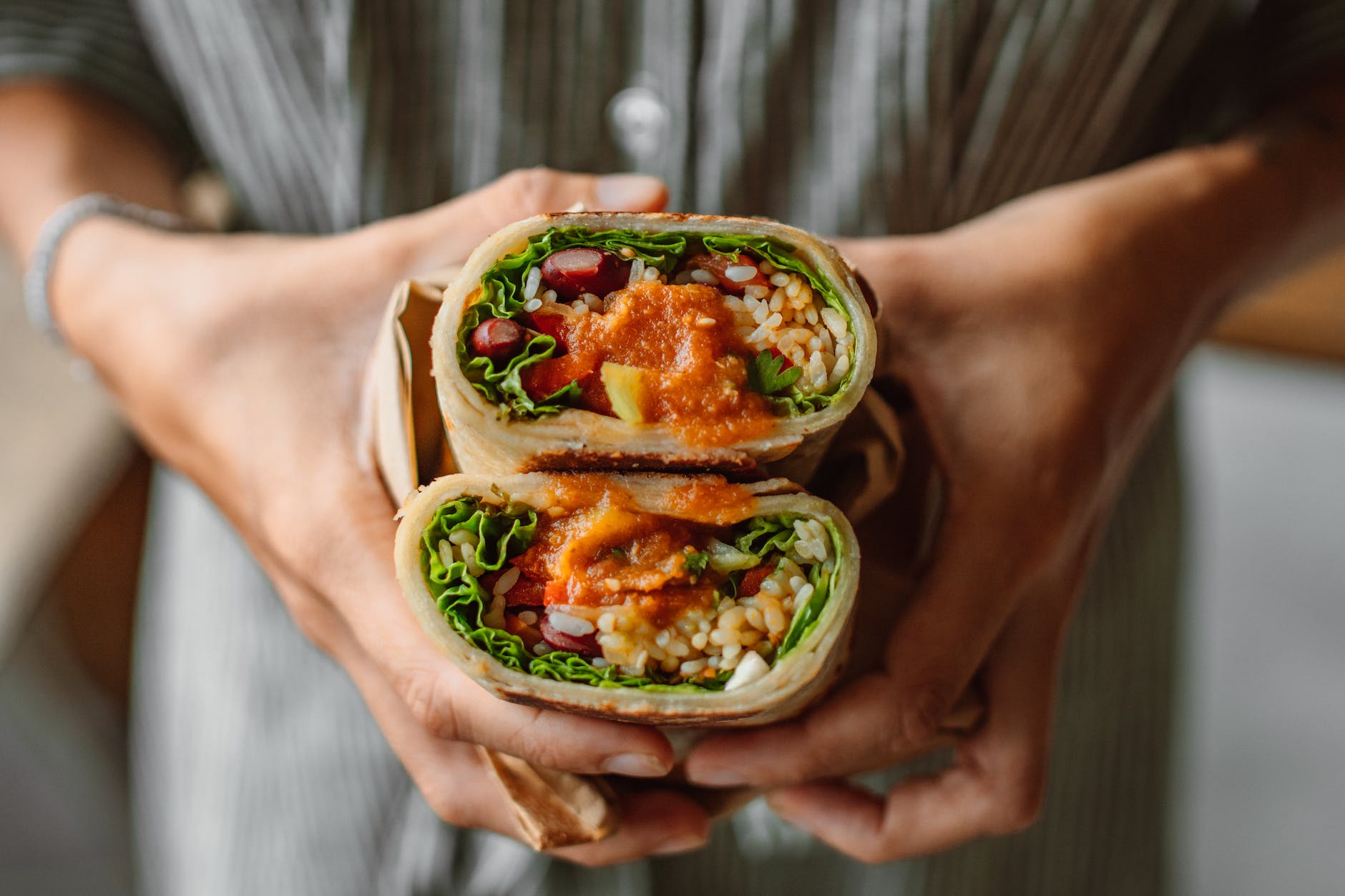 hands holding vegetable wrap