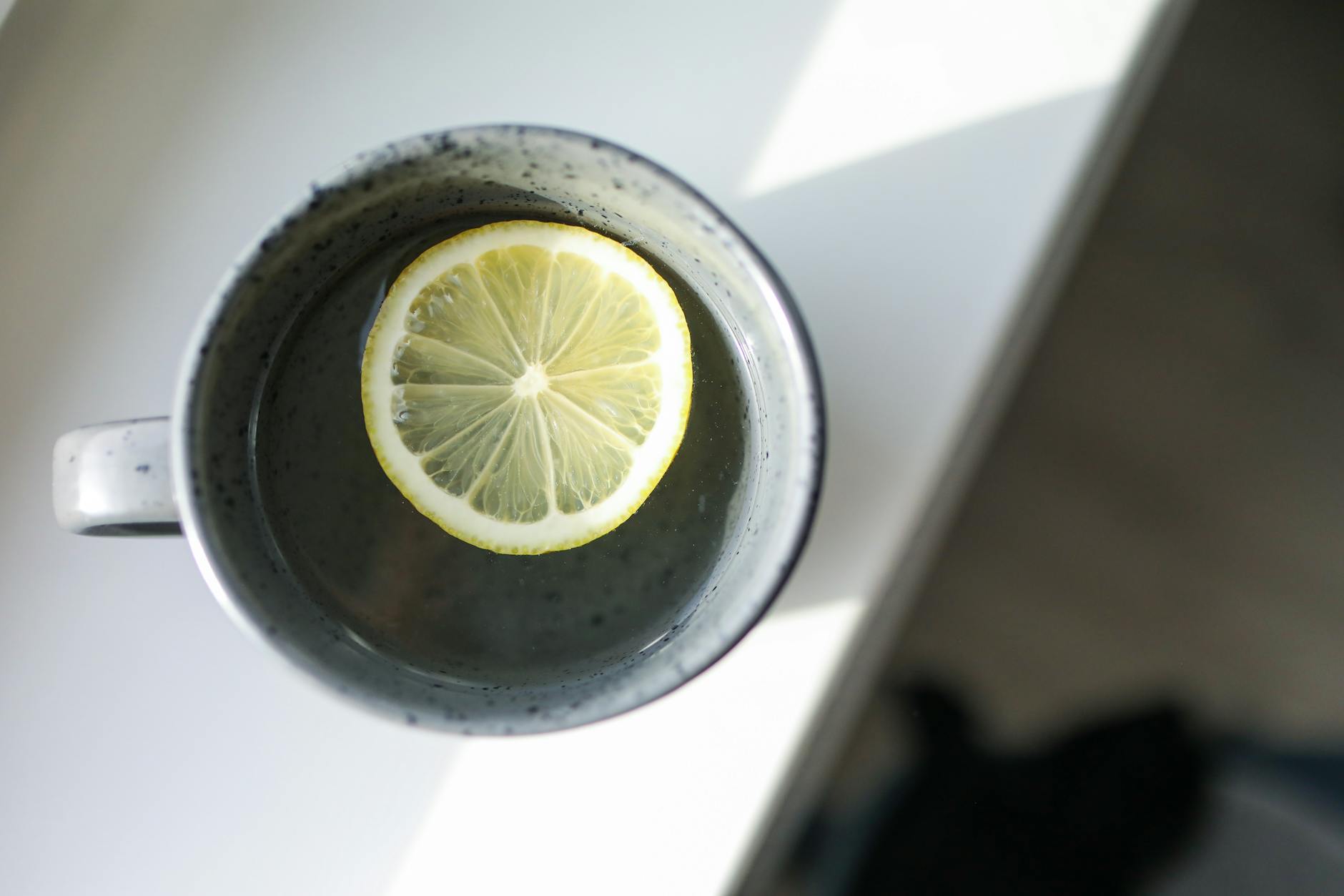 close up photo of mug with sliced lemon