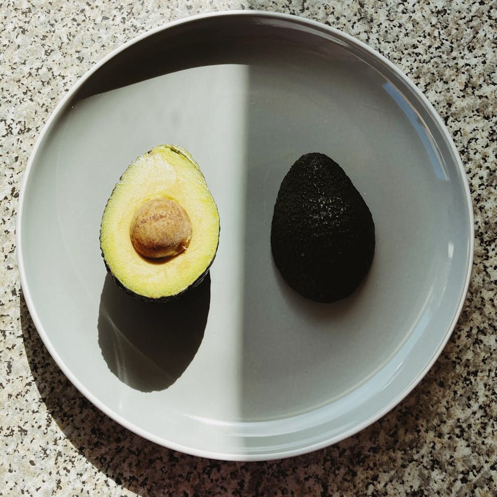parts of healthy avocado on plate