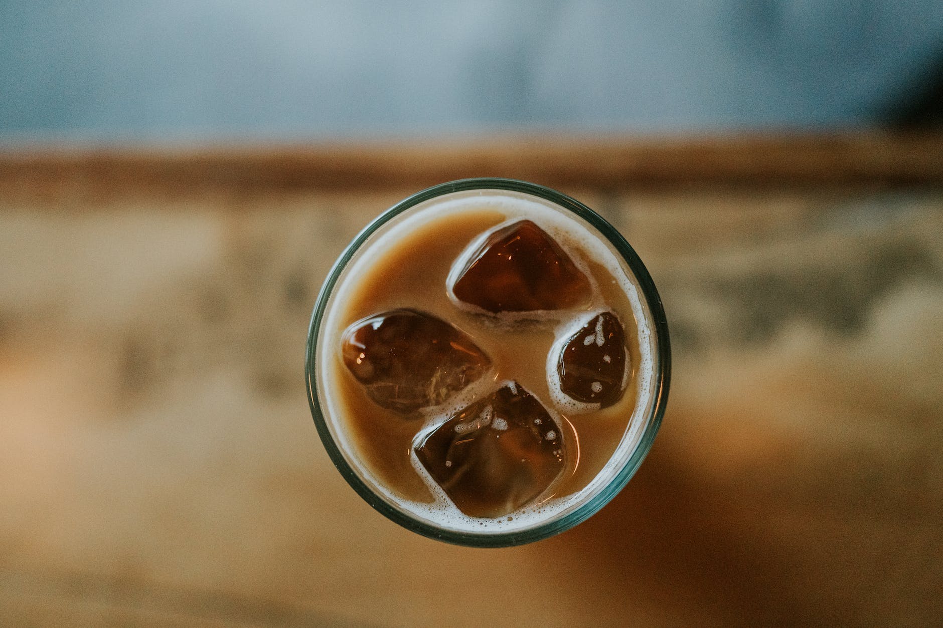 a glass of iced coffee with ice cubes