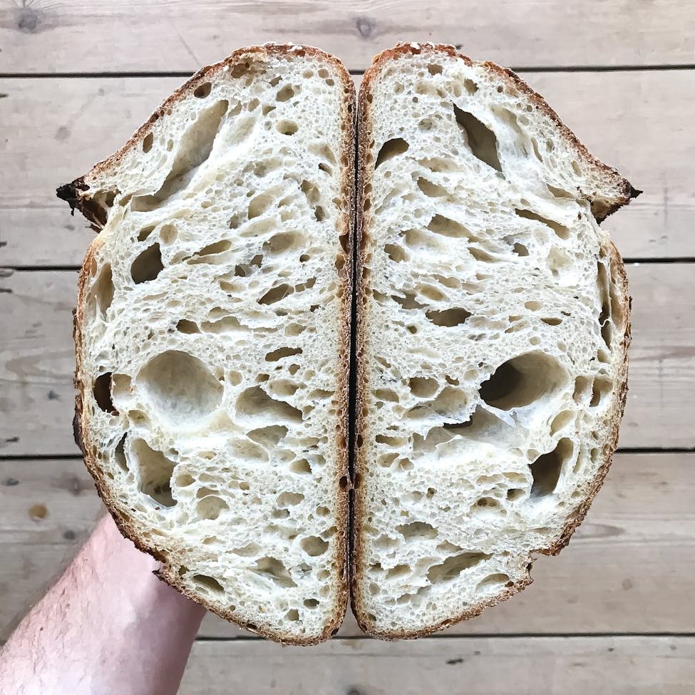 crop person with cut fresh bread